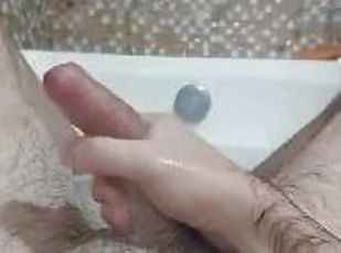 Solo man masturbating in the bathub