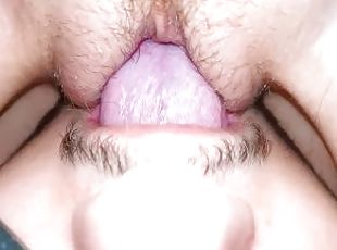 The wife moans from cunnilingus, close-up, sitting on her face with a wet pussy.