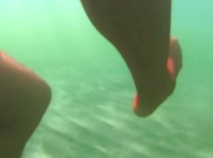 red stocking in the sea at the public beach