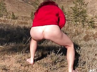 red-haired shameless with a naked ass in nature pissing