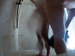 Skinny, fit blonde with tramp stamp filmed taking a shower