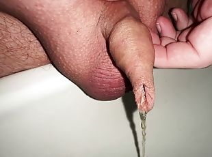 Plays with the foreskin of my micro cock while urinating