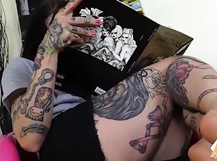 A tattooed girl puts her feet in front of your face