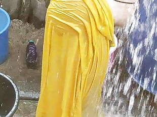 Indian house wife bathing outside