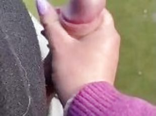 Hand job outside in soccer field