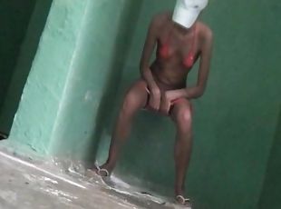 Nasty naked babe is pissing in the public toilet