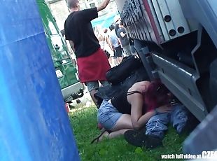 Oral young couple hiding behind a car