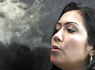 Latina blowing smoke sensually